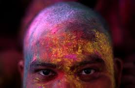 Man Daubed In Colours Looks On As He Takes Part In Lathmar Holi Celebrations Inside A Temple In Th Thomson Reuters Holi Celebration Color Color Festival