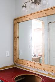 The frame overhung the mirror on either side by about 2 inches. Diy Mirror Frame Frame Your Bathroom Mirror For Less Than 20