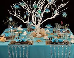 Stretch a (fishing) net across the tablecloth, sea shells and starfish symbolize the sea and beach. Ocean Theme Table Decorations Novocom Top