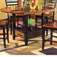 Dining table + wine rack + some additional storage space, so 2, or even 3 in 1. Steve Silver Abaco Ab200pt Ab200ptb Solid Wood Acacia Top Round Storage Base Counter Table With Drop Leaves Dunk Bright Furniture Pub Tables