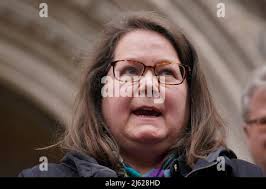 Fay Harris, whose father died from Covid-19, speaking outside the Royal  Courts of Justice, central