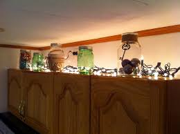 Use Different Size Mason Jars Filled With Different Objects Along With Christmas Lights To Add Light And Reflect With Images Christmas Lights Kitchen Cabinets Mason Jars