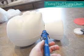 Place the fabric square over the ball, pressing it down onto the adhesive at the top. Diy Halloween Decorations Floating Head Hanging Ghosts Simply Designing With Ashley