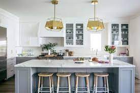 This stunning all grey kitchen looks amazing with the gold hardware and lighting, and i love the fresh white countertops and backsplash. White And Gray Kitchen With Gold Pendants And Dip Dyed Counter Stools Contemporary Kitchen