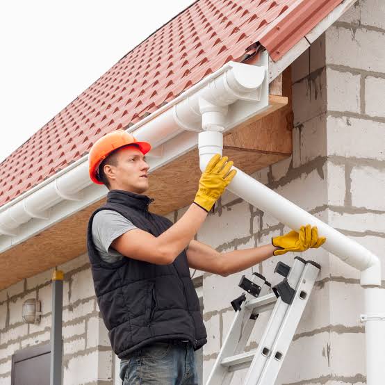 Gutter system with a downspout on the exterior of a house