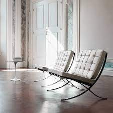The barcelona chair and ottoman make this room of chrome, glass and stone inviting. Here S How The Iconic Barcelona Chair Design Came To Be