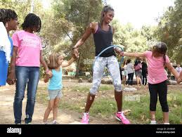 Olympian Lisa Leslie visits Girl Scouts at Camp Mariposa in Los Angeles to  rally support for the "Let's Get Her to Camp" campaign with Nestle Crunch  Girl Scout Candy Bars. Less than