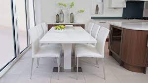 Minimalist design lead trend of modern simple life style, white round table top with three wooden legs is suit for theme of fast life and modern decoration. Modern Luxury White Dining Table Novocom Top