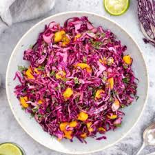 Baja fish tacos are crispy, made with beer battered fish, red cabbage slaw and creamy chipotle sauce. Red Cabbage Mango Slaw With Cilantro And Lime Recipe Elle Republic