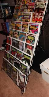 Place these racks on long stretches of counter, on top of figurine showcases, or on top of traditional bookshelves. Inexpensive Comic Display Rack Comic Display Comic Room Comic Book Display