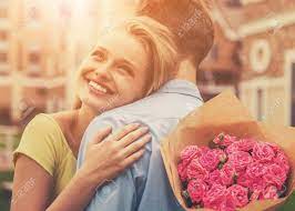 Discover and share the best gifs on tenor. Beautiful Young Couple On Wonderful First Date Attractive Cute Girl Hugging Her Boyfriend Holding Flowers And Smiling Large Bouquet Of Pink Roses Lovers Boy With Girl Enjoy Moment Stock Photo Picture And