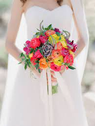 For this beachside wedding ceremony this bridal bouquet was filled with lilies, birds of paradise, and white fern wrapped with a mauve ribbon for. Bright Bridal Bouquets Are The Latest Wedding Flower Trend