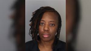 Woman charged after man found shot to death in burned car