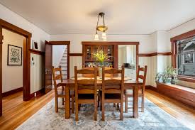 Amish dining room table, featuring a trestle table base and optional extension leaves. Sold True Tacoma Craftsman Michael Duggan Tacoma Homes