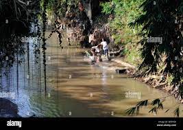 naked woman bathing in local river used communally near malang java  indonesia Stock Photo - Alamy