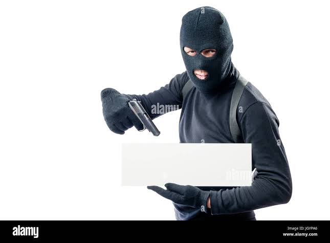 A criminal with a poster and a gun for your inscription Stock Photo - Alamy