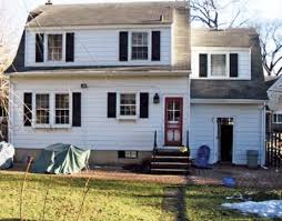 On the first floor, the guest room became an office, the breakfast alcove became an extension of the kitchen (with hidden laundry machines), and doors came out to create better flow from the kitchen to the living room. Dutch Colonial Home Remodel Before And After Home Renovation Photos