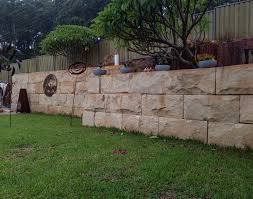 Retaining wall blocks come in a variety of colors and can be assembled to create straight or curved walls for terraced yards and seating walls. Australian Sandstone Logs Stone Blocks Retaining Walls Landscapes