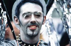 Context: Close up of Eddie in silver face paint and silver eye lashes.