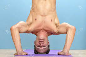 Shirtless Muscular Man Performs Three-point Head Stand With Hands On Floor  Stock Photo, Picture and Royalty Free Image. Image 16734470.