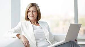 Senior lady coach or mentor showing thumb up standing over satisfied clients. The Art Of War Advice For Older Women In Business Sixty And Me
