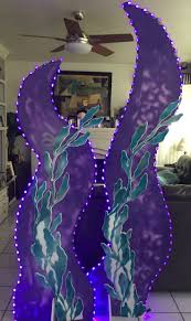 PACIFIC PARADISE Seaweed cutout, homemade stencil made out of foam board.  Spray paint. 6 and 7ft tall. Led purple lights. Magalie Sarnataro's props