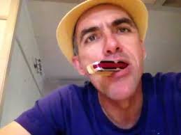 How to play harmonica hands free