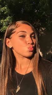 A Classy Butterfly Haircut On Dark Brown Hair With Layers And Curved Ends  With Curtain Bangs ...