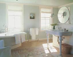 It features a vessel sink and a freestanding tub with a platform made of wood. Installing Hardwood Floors In A Bathroom