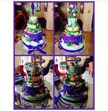 Browse the baby shower section of a party supply store for the mardi gras king cake baby, where plastic babies are often sold by the dozen. Mardi Themed Diaper Cake Diaper Cake Baby Shower Decorations Cake