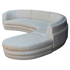 The wooden feet of the chair and ottoman have a bit of staining. Curved Sofa Chaise 1stdibs