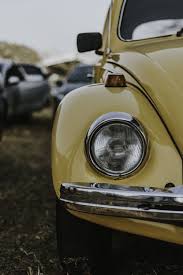 The Passenger Side Headlight Of A Yellow Car Yellow Aesthetic Yellow Car Aesthetic Vintage