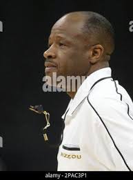 Missouri head coach Mike Anderson watches players, Jarrett Sutton, left,  Tyler Stone, right, and John Underwood run as they participate in their  first NCAA college basketball practice of the season Friday, Oct.