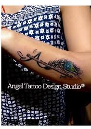 Peacock Feather With Flute And Letter A Made On Wrist At Angel Tattoo Design Studio Gurgaon Alphabet Tattoo Designs Tattoo Lettering Feather Tattoos