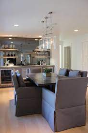 A spacious screened porch offers a fireplace and wet bar for entertaining outdoors. Dining Room Wet Bar Transitional Dining Room Talbot Cooley Interiors