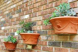 I love how the orange plants sizzle next to the thermometer and clock. 24 Creative Garden Fence Ideas