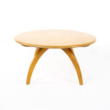 The walnut top rests on an ebonized wooden base with copper socks and a terrazzo stone circle in the centre. Heywood Wakefield Mid Century Round Coffee Table At 1stdibs