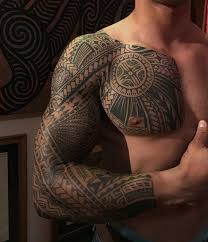 This tattoo includes a black inked tribal arrow, with lots of greys, inked detailing, and feathers on the top. 70 Awesome Tribal Tattoo Designs Cuded Tribal Tattoo Designs Tribal Arm Tattoos Tribal Tattoos