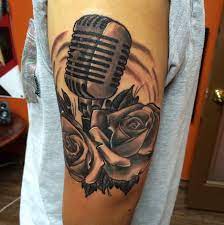 Amazing black and grey realistic tattoo style of microphone and rose motive done by artist alberto escobar | large tattoo photo 26534 | world tattoo gallery Microphone And Roses Tattoos By Christopher O Toole Tattoonow