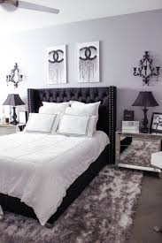 The vintage appeal of chenille bedding along with a repurposed door turned headboard lead the way for the farmhouse shabby chic design of this bedroom. Black White Bedroom Decor Chic Glam Bedroom Decor Blondie In The City Hayley Larue Be White Bedroom Decor Apartment Bedroom Decor White Bedroom Design