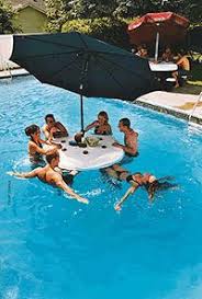 Floating Pool Bar I Might Understand This If There Was No Umbrella But Apparently With This Invention You Can Be In Pool Shade Pool Umbrellas Pool Life