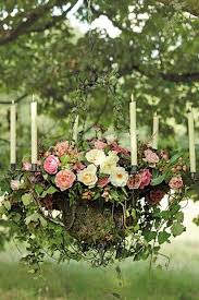 A Wire Chandelier Filled With Moss Soil Plants And Candles Hangs From A Tree This Was U Hanging Flower Arrangements Flower Arrangements Beautiful Flowers