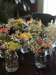 Clearance Flowers From Kroger Broken Up Separately Into Mason Jars As Centerpieces With Added Baby S Breath Table Decorations Mason Jars Centerpieces