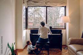 Mom trying to play the piano at home while attending to naughty children  than wants to