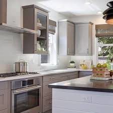 This space contrasts open wood shelving and textured leather bar stools with a glossy tile backsplash and elegant, modern light fixtures. Mosaic Monday 5 Elegant Kitchens With Classic White Subway Tile