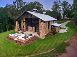 White and black exterior design with gray garage doors. 12 Stunning Brick House With Metal Roof Ideas Jimenezphoto