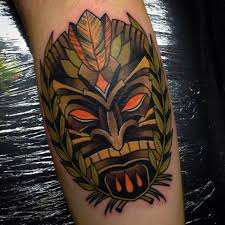 A black gas mask with big red eyes. Tiki Mask Tattoo On Leg Calf
