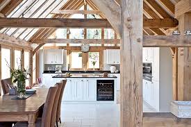 Design ideas for a farmhouse kitchen in other with green cabinets, white splashback, metro tiled splashback, white appliances, an island, grey floors, exposed beams, a timber clad ceiling and a vaulted ceiling. Vaulted Ceiling Ideas For Updated Elegant Striking Drama Decor Aid