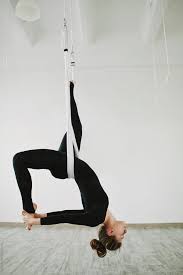 Young Woman Upside Down Doing Anti Gravity Yoga Stocksy United Aerial Yoga Poses Anti Gravity Yoga Aerial Yoga