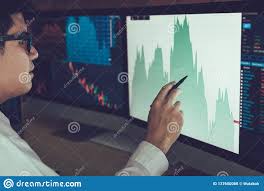 Young Businessman Hand Pointing To Stock Market Chart On